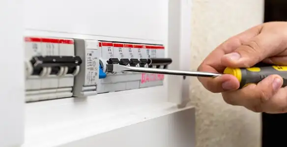 electrical panel upgrade service showing technician adjusting circuit breakers during system upgrade in Chico, CA