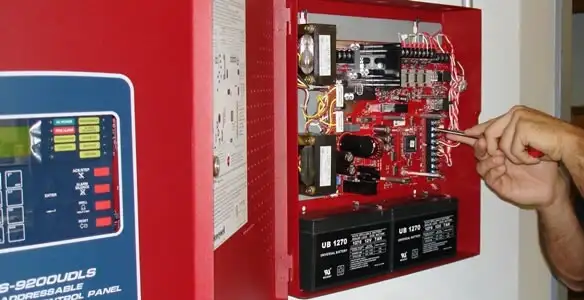 fire alarm installation service showing technician configuring fire alarm control panel in Chico, CA