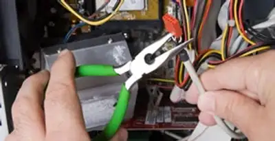 Licensed electrical contractor performing electrical repair with tools in Durham, CA