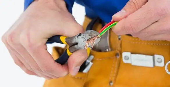 licensed electrician securing electrical wiring with professional tools during service work in Chico, CA