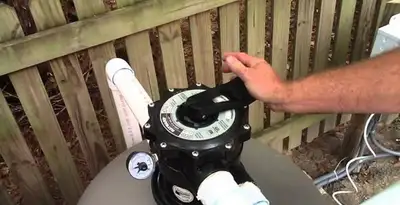 pool pumps service showing professional adjustment of pool pump control system in Chico, CA